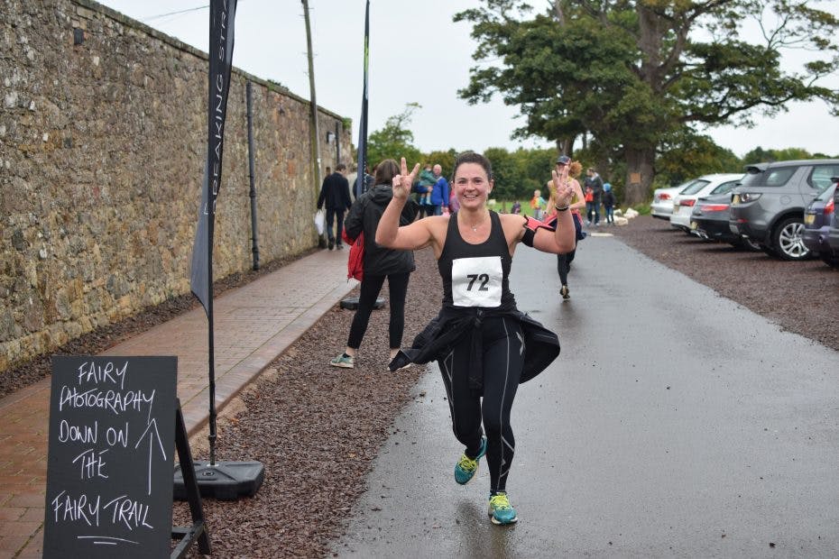 smiling woman running mid runnyegg 10k